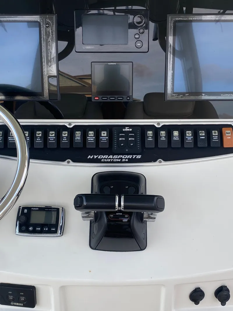 Slide: The Image of 2017 Hydra-Sports 3400 Center Console dashboard with steering wheel and control panel. - 11