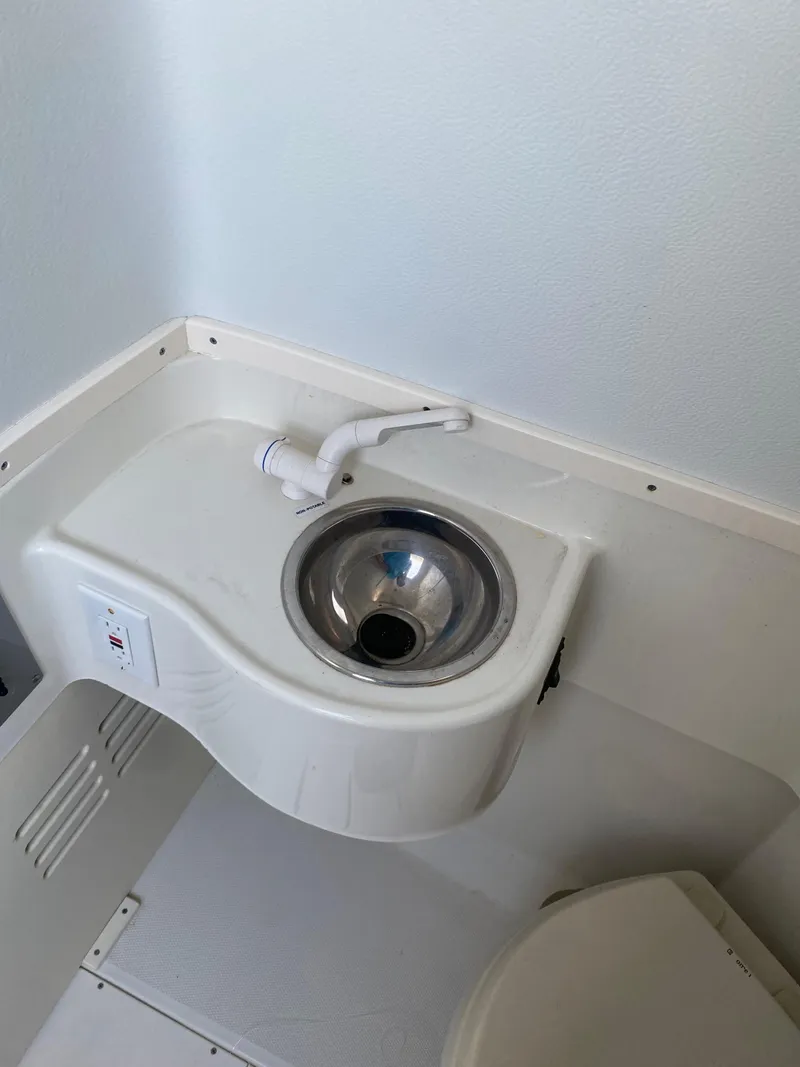 Slide: The Image of 2017 Hydra-Sports 3400 Center Console boat interior with compact bathroom amenities. - 14