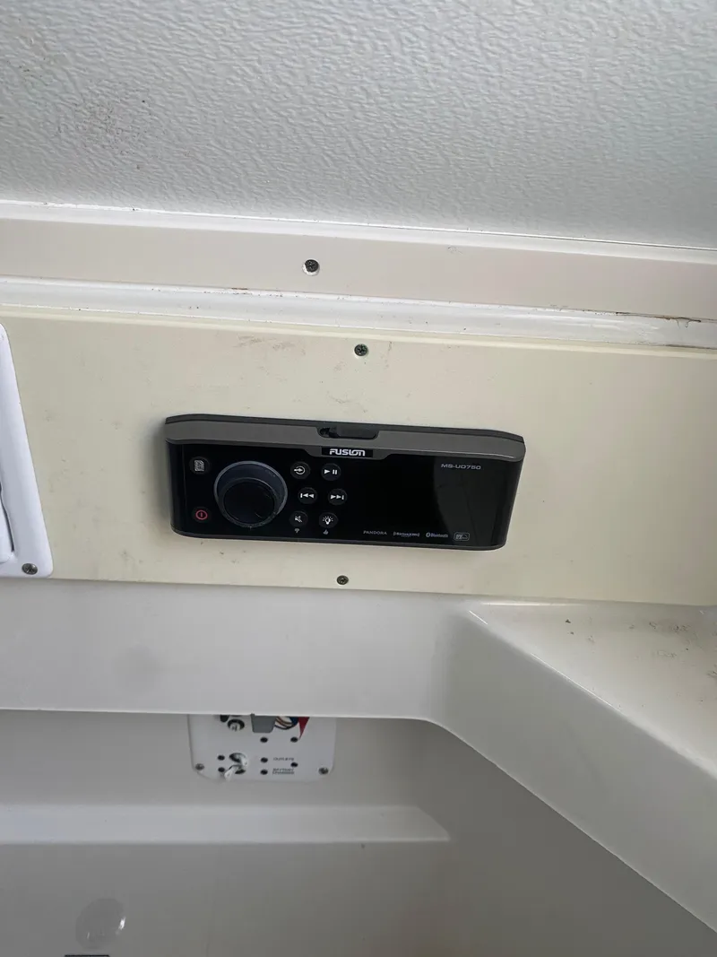 Slide: The Image of 2017 Hydra-Sports 3400 Center Console control panel with red switches and dials. - 16