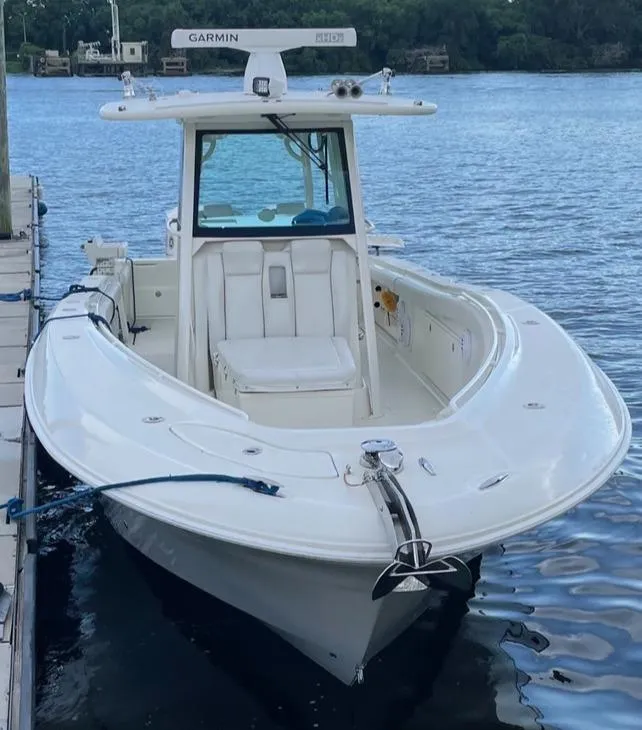 Slide: The Image of 2017 Hydra-Sports 3400 Center Console boat with Yamaha engine, docked near a marine center. - 2