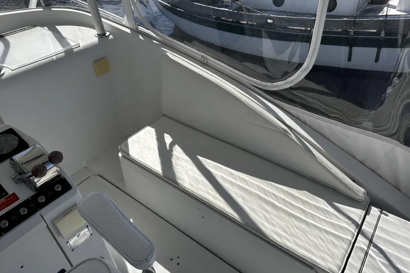 Slide: The Image of 1997 Luhrs 32 Open boat interior with white seating and control panel. - 12