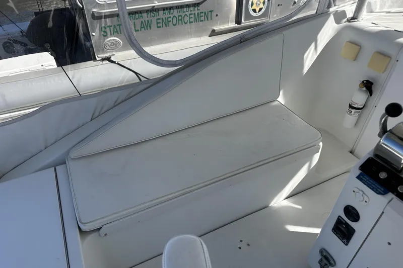 Slide: The Image of 1997 Luhrs 32 Open boat interior with white seating and control panel. - 13