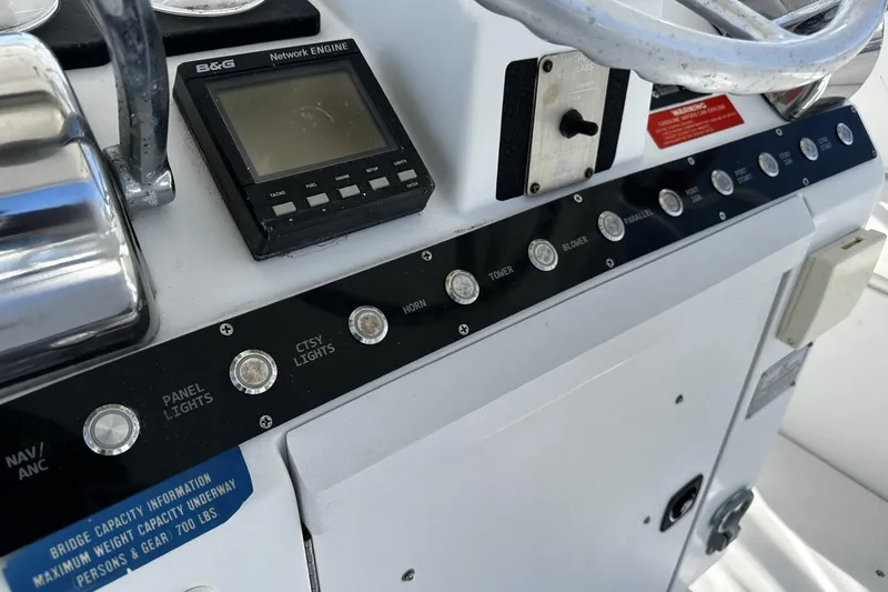 Slide: The Image of Control panel of a 1997 Luhrs 32 Open boat with various switches and a B&G display. - 15