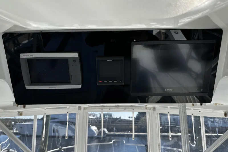 Slide: The Image of 1997 Luhrs 32 Open boat dashboard with Garmin navigation displays. - 17