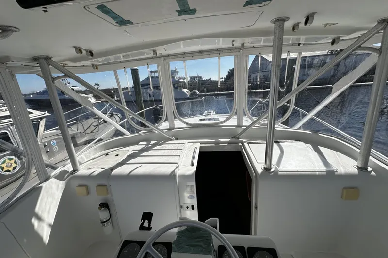 Slide: The Image of 1997 Luhrs 32 Open boat interior with helm, docked at marina. - 19