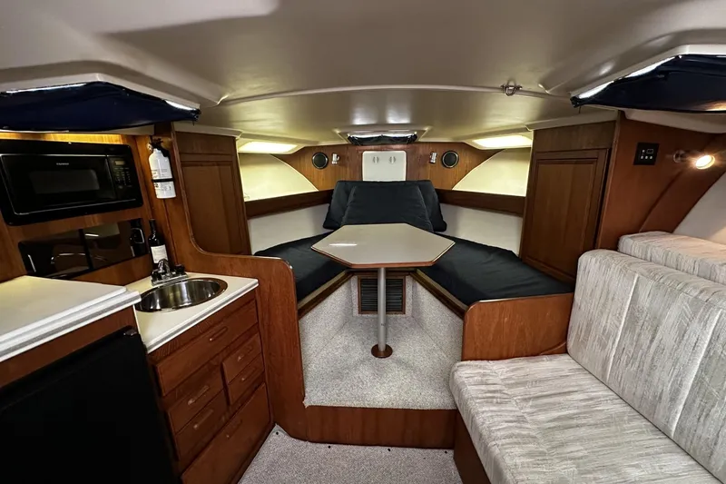 Slide: The Image of 1997 Luhrs 32 Open cabin interior with kitchenette, seating, and sleeping area. - 20