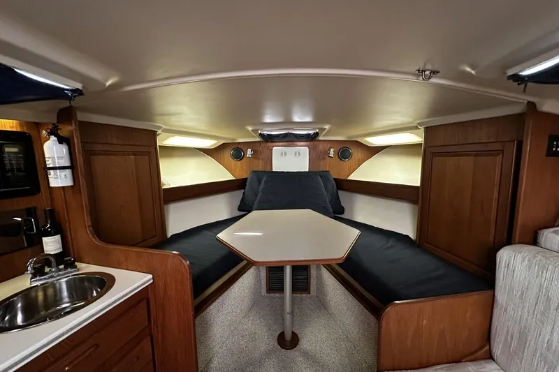 Slide: The Image of Interior of 1997 Luhrs 32 Open boat with cozy seating and wooden cabinetry. - 24