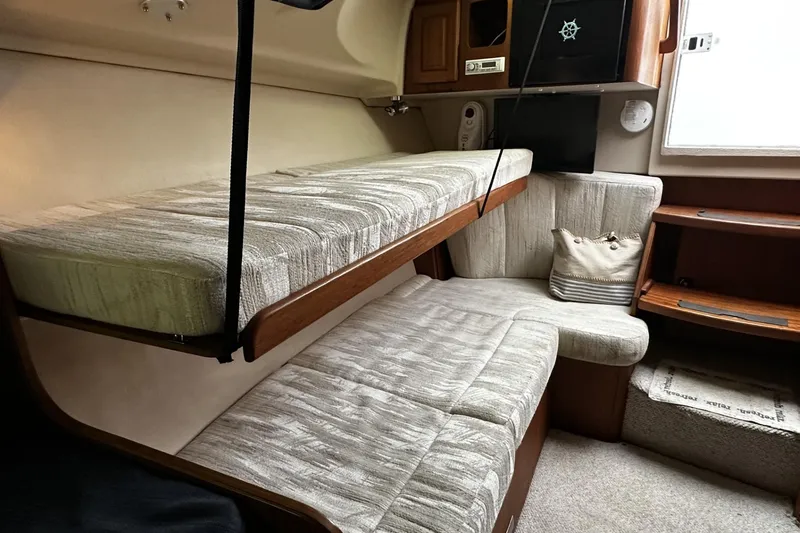 Slide: The Image of 1997 Luhrs 32 Open cabin interior with bunk beds and seating area. - 28
