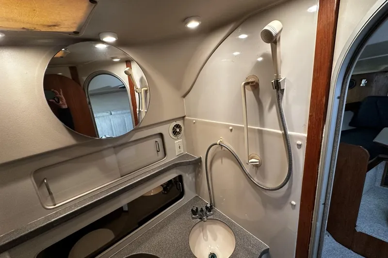 Slide: The Image of 1997 Luhrs 32 Open boat bathroom with shower, sink, and mirror. - 34