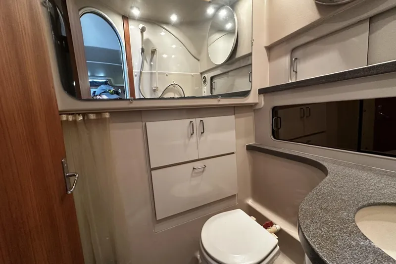 Slide: The Image of 1997 Luhrs 32 Open boat bathroom with modern fixtures and storage cabinets. - 35