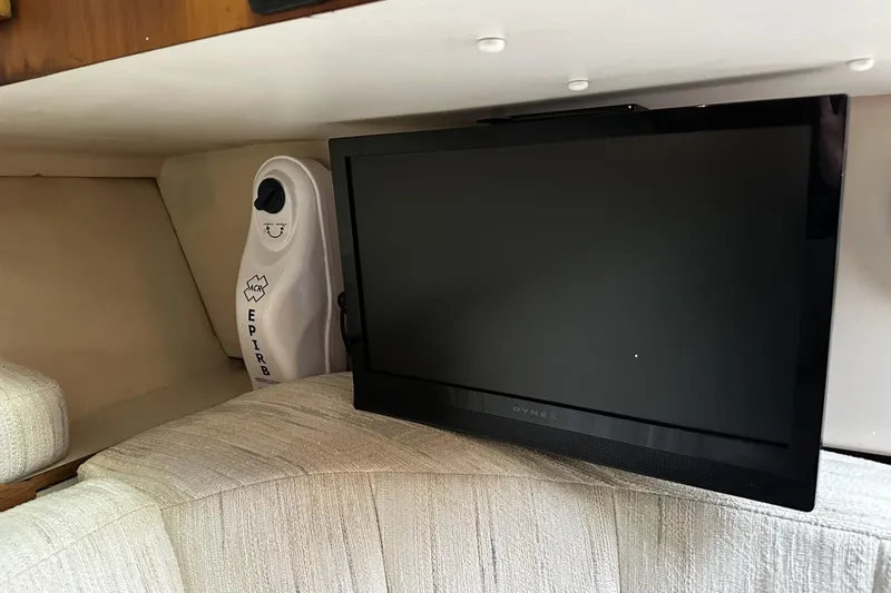 Slide: The Image of 1997 Luhrs 32 Open cabin interior with TV and EPIRB device. - 37