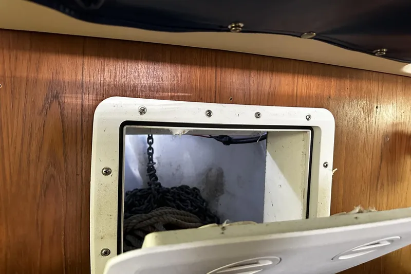 Slide: The Image of Anchor chain compartment on 1997 Luhrs 32 Open boat, viewed through a small hatch. - 40