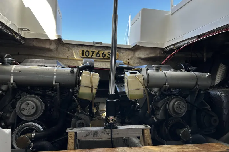 Slide: The Image of Engine compartment of a 1997 Luhrs 32 Open boat, showcasing dual engines. - 44