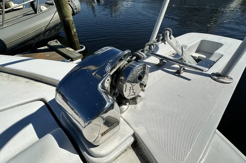 Slide: The Image of Anchor winch on 1997 Luhrs 32 Open boat deck by the water. - 48