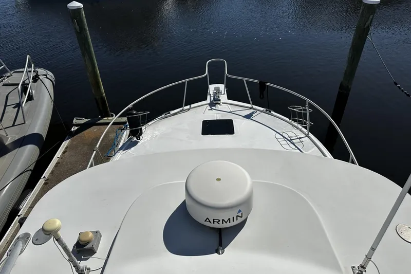 Slide: The Image of 1997 Luhrs 32 Open boat docked, featuring Garmin equipment on deck. - 49