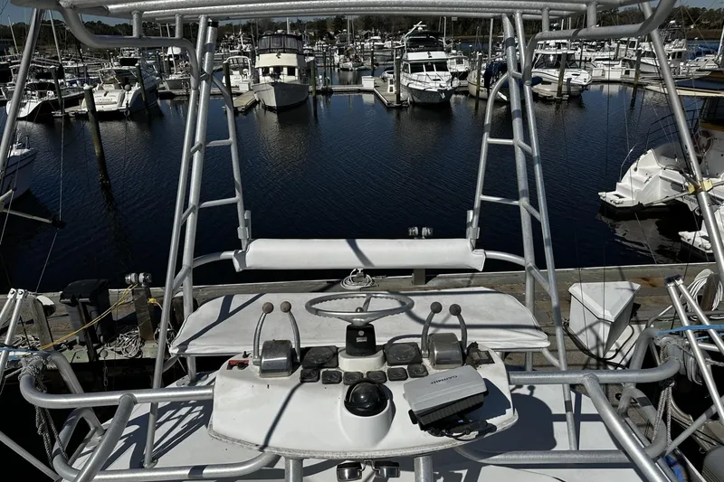 Slide: The Image of 1997 Luhrs 32 Open boat helm with marina view in the background. - 50