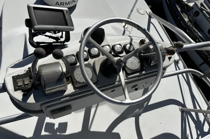 Slide: The Image of 1997 Luhrs 32 Open boat helm with steering wheel and navigation controls. - 51