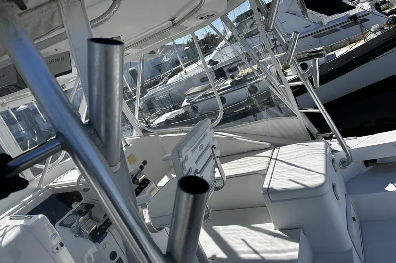 Slide: The Image of 1997 Luhrs 32 Open boat interior with helm, seating, and fishing rod holders. - 54