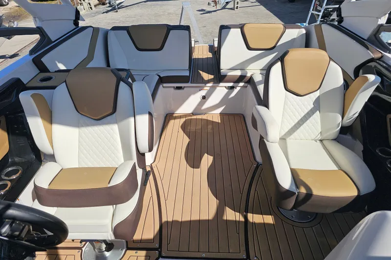 Slide: The Image of 2022 Yamaha Boats 252SD interior with tan and white seating, showcasing luxury design. - 12