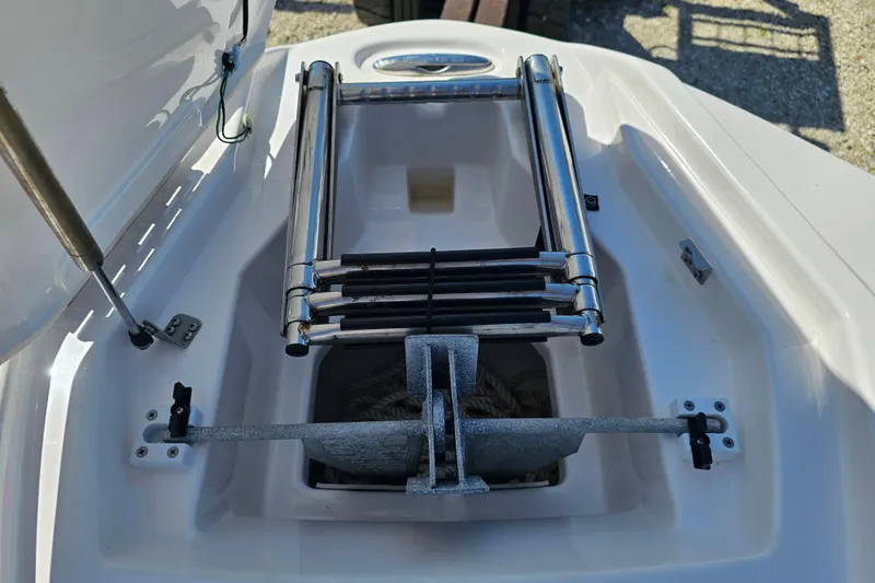 Slide: The Image of 2022 Yamaha Boats 252SD anchor compartment with stainless steel ladder. - 15