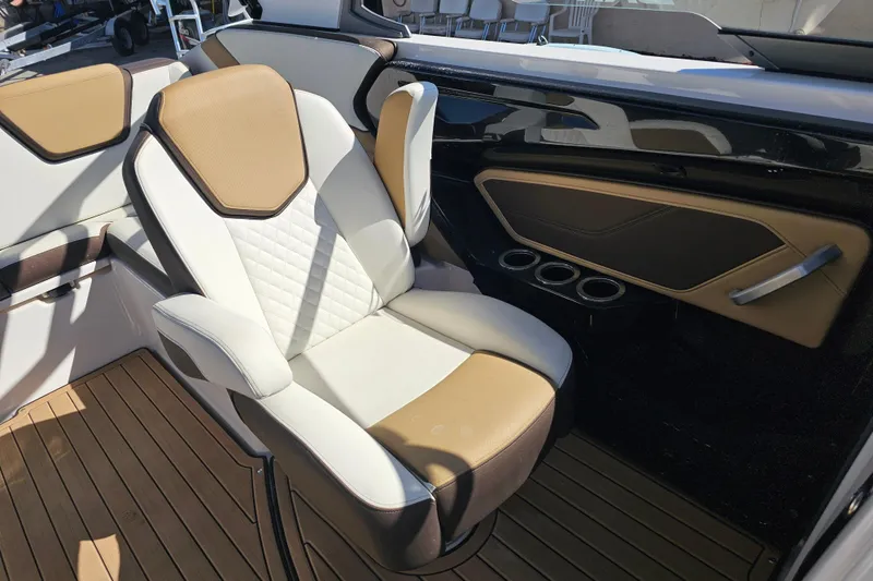 Slide: The Image of 2022 Yamaha Boats 252SD interior with tan and white seating, sleek design. - 17