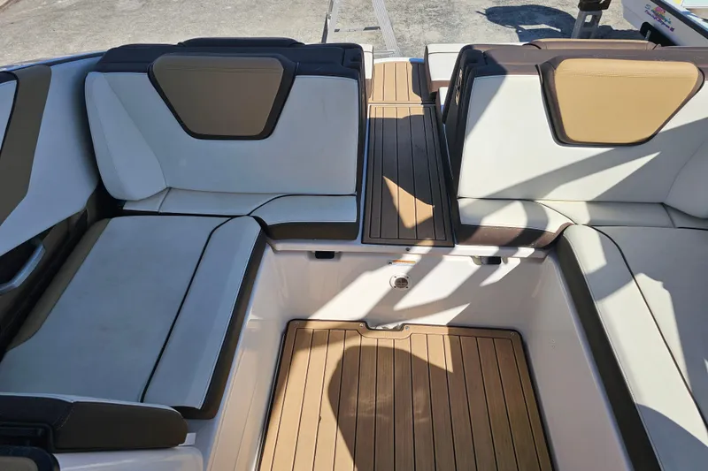 Slide: The Image of 2022 Yamaha Boats 252SD interior with sleek seating and wood-style flooring. - 18