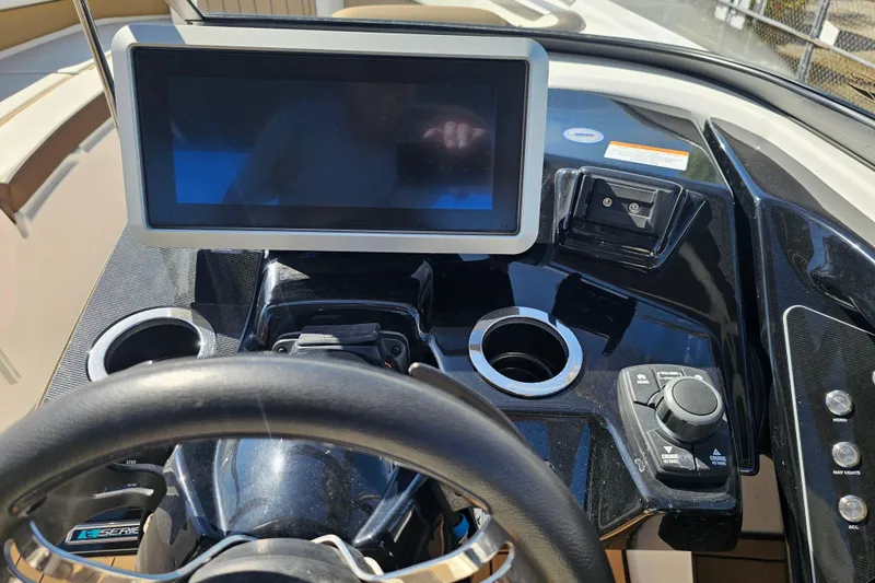 Slide: The Image of 2022 Yamaha Boats 252SD dashboard with touchscreen, steering wheel, and control panel. - 21