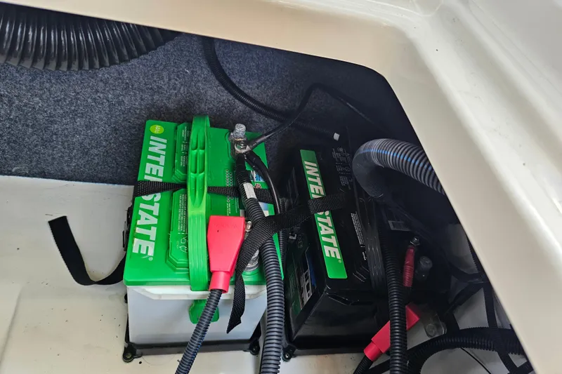 Slide: The Image of Battery compartment of 2022 Yamaha Boats 252SD with Interstate batteries and wiring. - 26