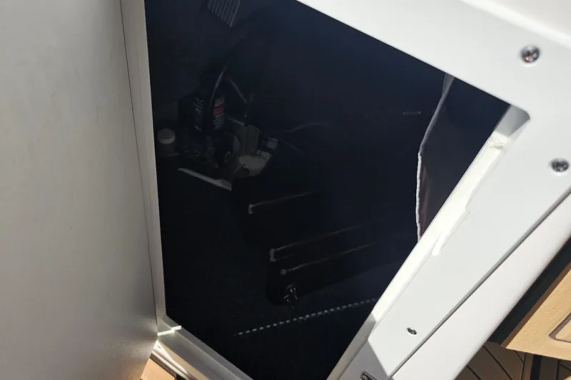 Slide: The Image of Interior compartment of 2022 Yamaha Boats 252SD, showcasing storage and equipment. - 28