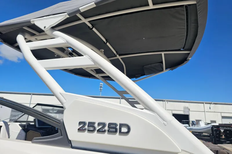 Slide: The Image of 2022 Yamaha Boats 252SD with canopy against blue sky. - 3