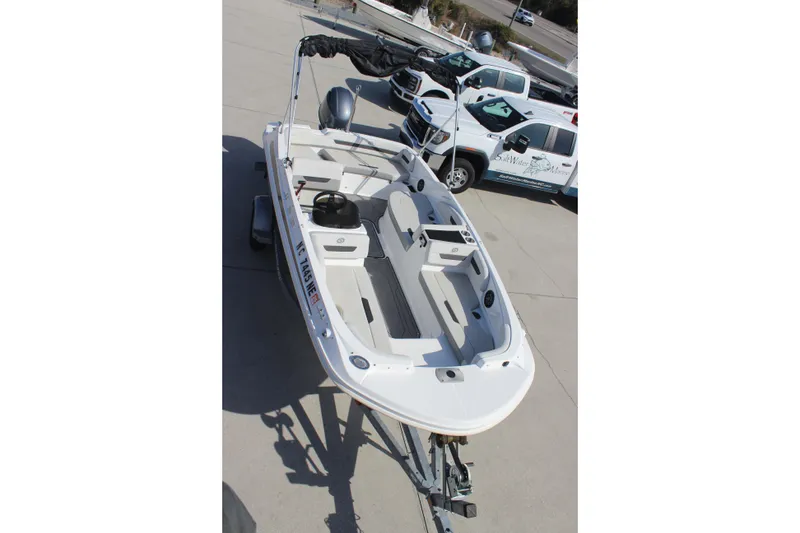 Slide: The Image of 2021 Hurricane SunDeck Sport 185 OB boat on trailer, parked outdoors. - 11