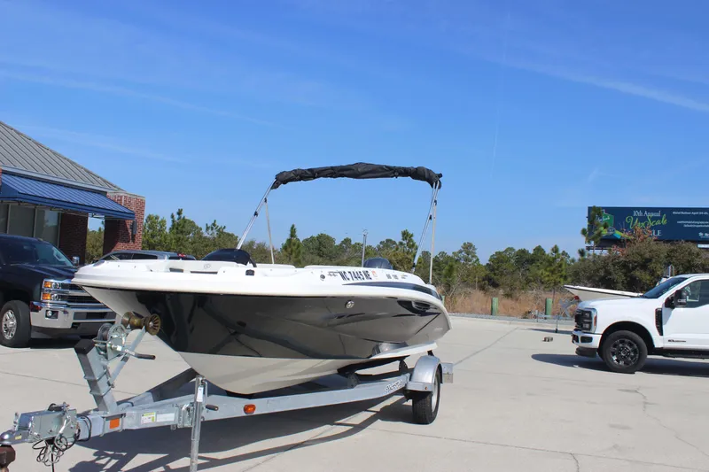 Slide: The Image of 2021 Hurricane SunDeck Sport 185 OB boat on trailer in parking lot. - 2