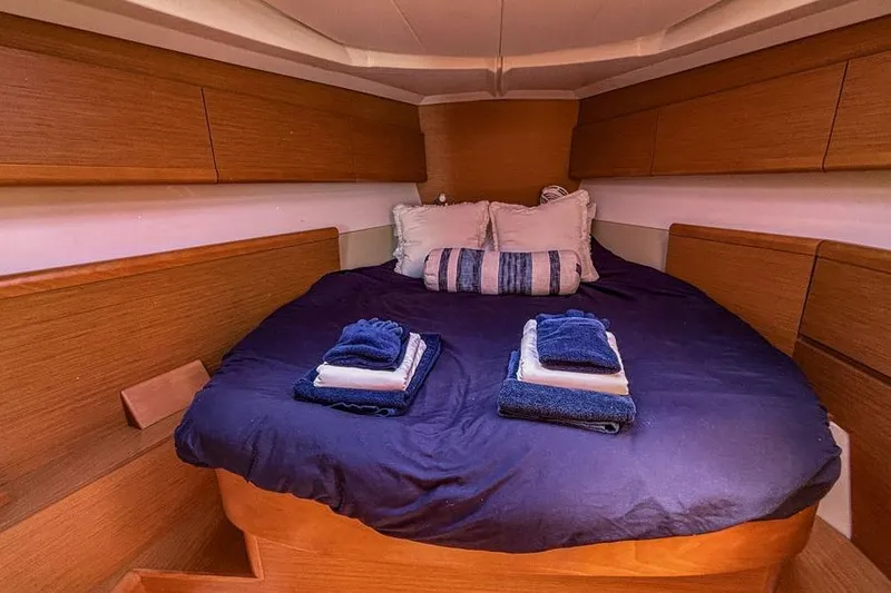 Slide: The Image of Cozy cabin interior of 2011 Jeanneau Sun Odyssey 44 with neatly arranged bedding. - 13