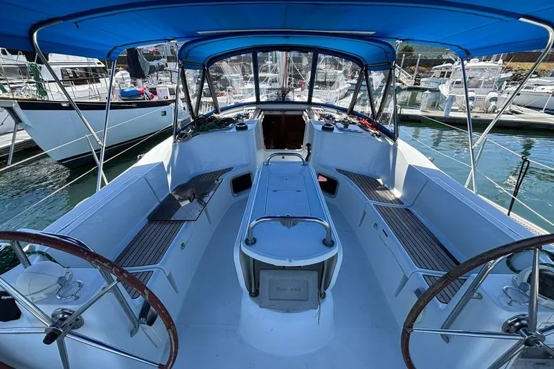 Slide: The Image of Cockpit of 2011 Jeanneau Sun Odyssey 44 sailboat with blue canopy in marina. - 3