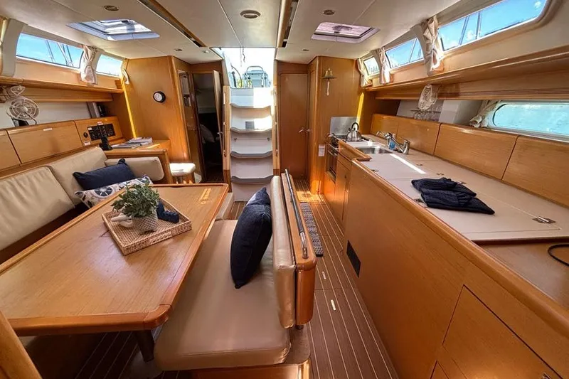 Slide: The Image of Interior of 2011 Jeanneau Sun Odyssey 44 yacht with modern kitchen and dining area. - 10