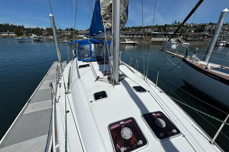 Slide: The Image of Jeanneau Sun Odyssey 44 sailboat docked, 2011 model, with clear blue sky and marina view. - 2