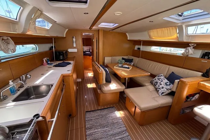 Slide: The Image of Interior of 2011 Jeanneau Sun Odyssey 44 yacht with modern kitchen and cozy seating area. - 6