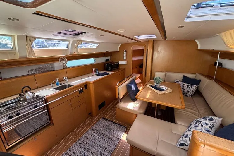 Slide: The Image of Interior of 2011 Jeanneau Sun Odyssey 44 yacht with kitchen and seating area. - 7