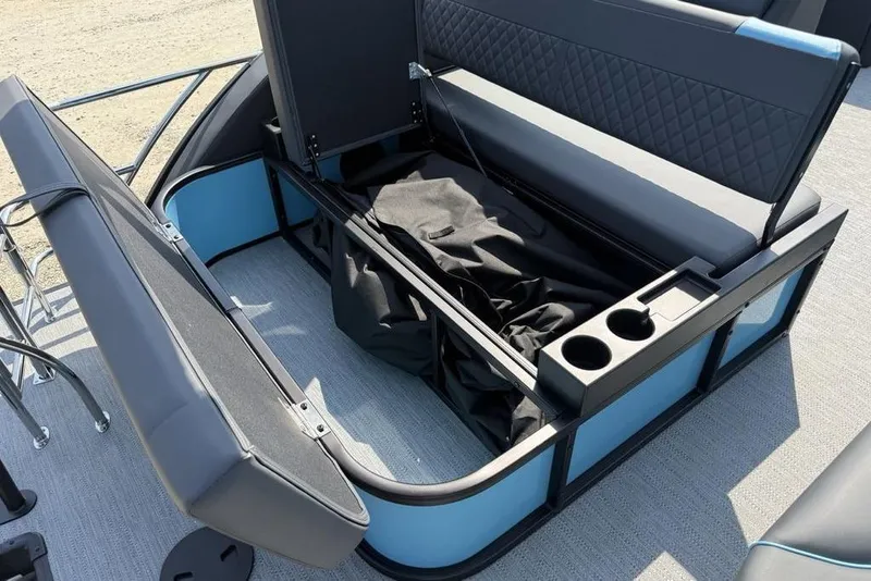 Slide: The Image of 2026 Godfrey Sweetwater 2286 SFL boat interior with open storage and cup holders. - 10