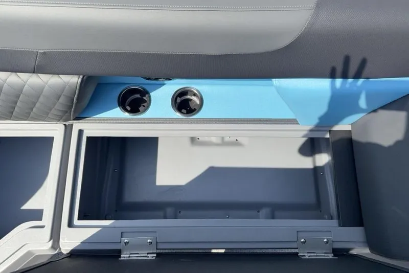 Slide: The Image of Interior storage compartment of 2026 Godfrey Sweetwater 2286 SFL boat with cup holders. - 12