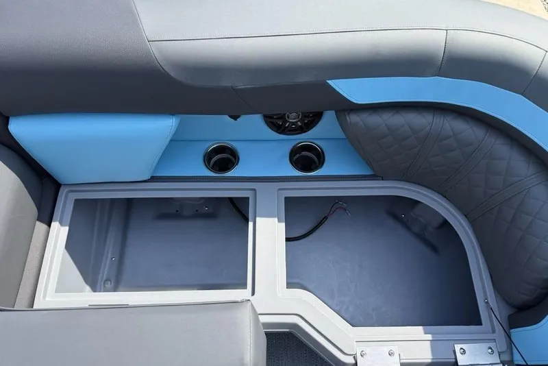 Slide: The Image of Interior seating and storage of 2026 Godfrey Sweetwater 2286 SFL boat, featuring cup holders. - 21