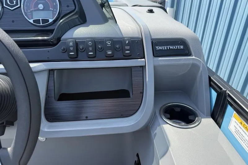 Slide: The Image of Dashboard of 2026 Godfrey Sweetwater 2286 SFL boat with controls and cup holder. - 30