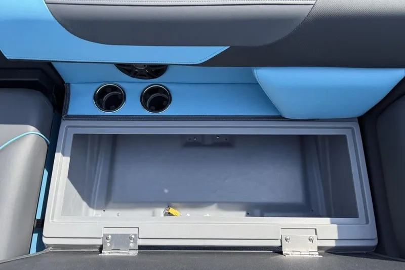 Slide: The Image of 2026 Godfrey Sweetwater 2286 SFL boat storage compartment with cup holders and blue interior. - 35
