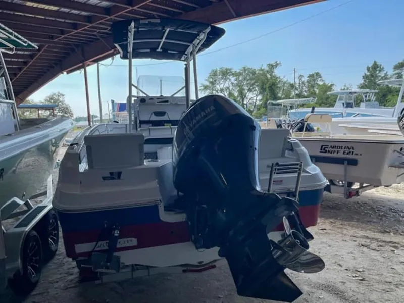 Slide: The Image of 2024 Wellcraft 202 Fisherman boat with outboard motor in covered storage. - 15