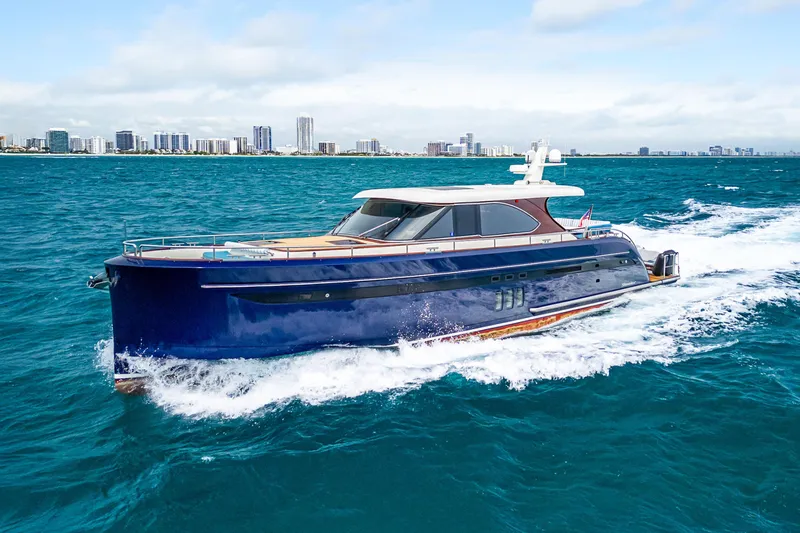 The Image of 2021 Steeler 60S Performance yacht cruising on blue ocean near city skyline. - 1