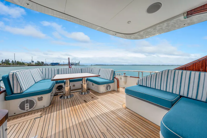 Slide: The Image of Luxurious 2021 Steeler 60S Performance yacht deck with striped seating and ocean view. - 16
