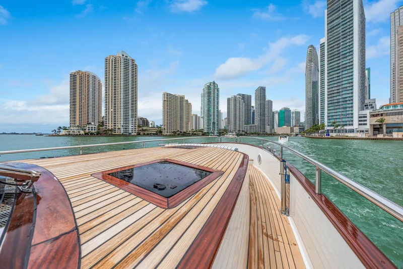 Slide: The Image of Luxury yacht Steeler 60S Performance 2021 cruising near city skyline, clear blue sky. - 19