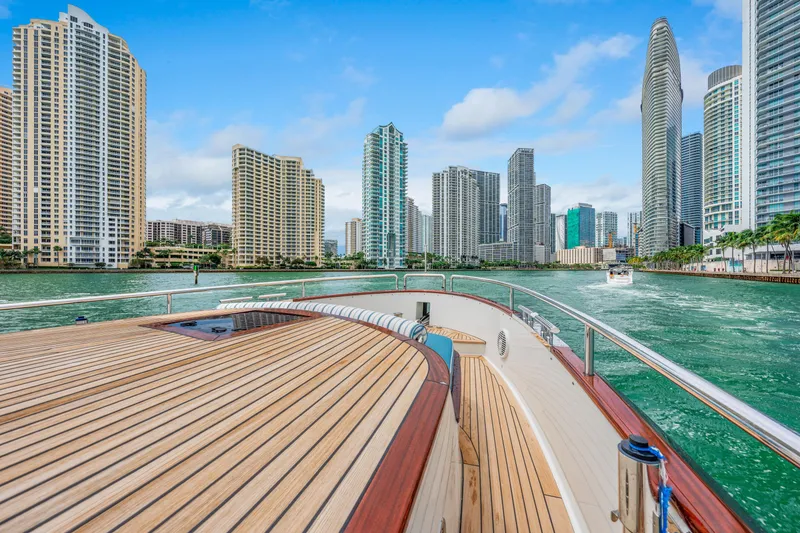 Slide: The Image of Luxury Steeler 60S Performance yacht cruising near city skyline, 2021 model. - 20