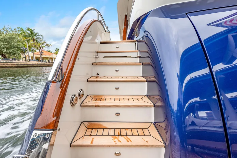 Slide: The Image of Luxury yacht steps on a 2021 Steeler 60S Performance, featuring sleek design and wood accents. - 25