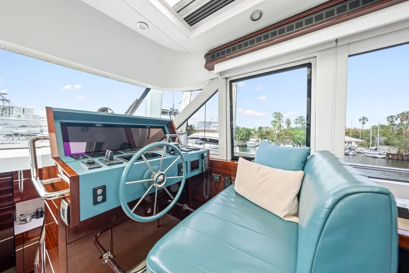 Slide: The Image of Helm of 2021 Steeler 60S Performance yacht with turquoise seating and modern controls. - 30